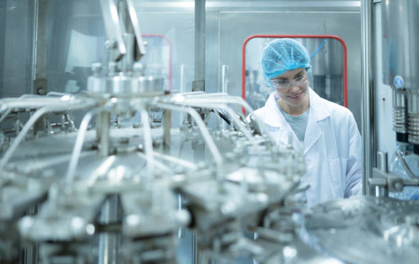 istock Female quality control worker inspecting water bottle on production line in drinking water factory 1539728296