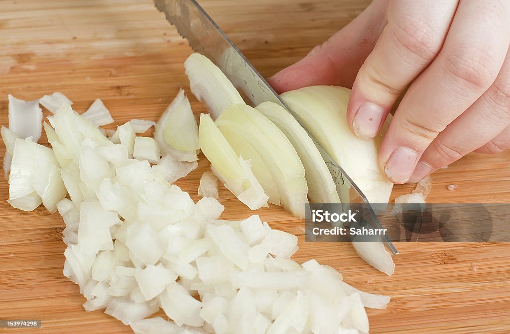 Hands, Cutting Onions The hands cutting onions on a chopping board Onion Stock Photo