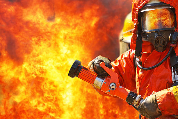 istock A firefighter battling a fierce blaze 153974362