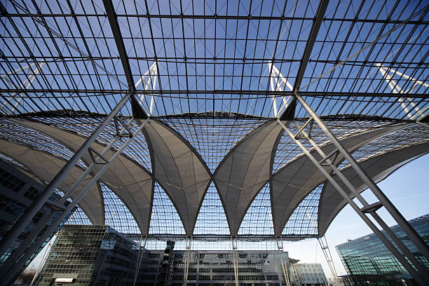 beautiful glass ceiling with business buildings XXXL at munich airport - huge ceiling connection from terminal 1 and 2 munich airport stock pictures, royalty-free photos & images