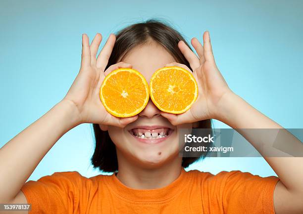 Little Girl Using Oranges As Glasses Stock Photo - Download Image Now - Beauty In Nature, Brown Eyes, Brown Hair