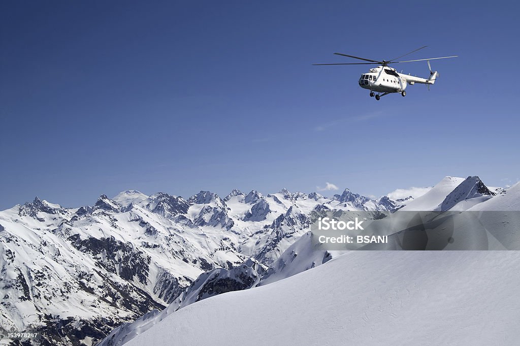 Helicopter in snowy mountains Heli-Skiing Stock Photo