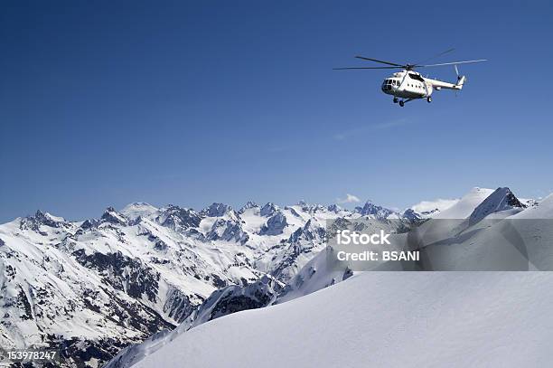 Helicopter In Snowy Mountains Stock Photo - Download Image Now - Heli-Skiing, Helicopter, Beauty In Nature