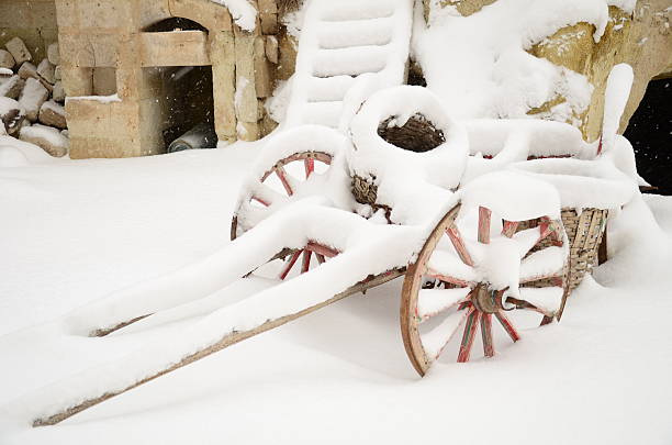wooden cart under snow wooden cart under snow at the garden of a house made by stone covered wagon horse cart snow winter stock pictures, royalty-free photos & images
