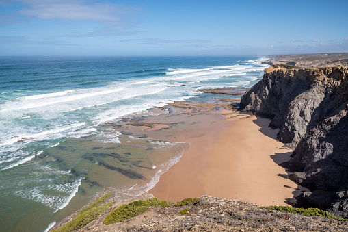 rock cliff at praia de Monte Clerigo beach in a sunny day with low tide, Aljezur, Vicentine Coast, Algarve, Vicentine Coast, Portugal