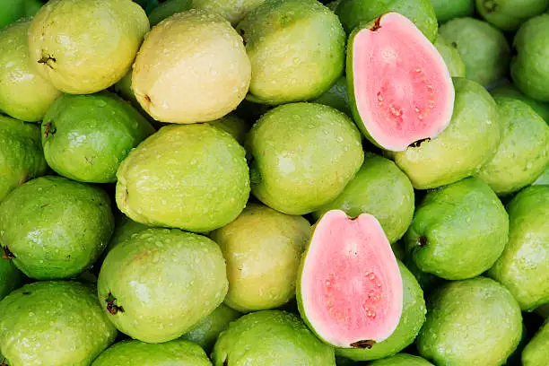Fresh guavas with pink flesh being sold in a Vietnamese market