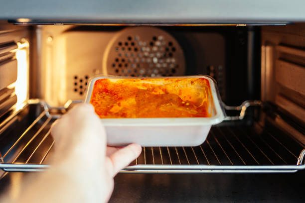 istock Man putting ready meal in the microwave oven at home 1539821849