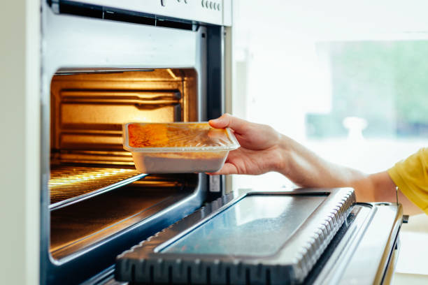istock Man putting ready meal in the microwave oven at home 1539822852