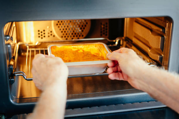 istock Man putting ready meal in the microwave oven at home 1539822929