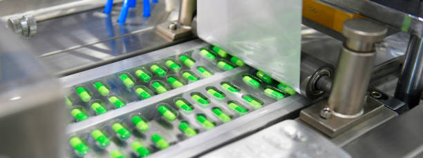 istock Green capsule medicine pill production line 1539826246