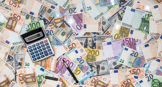 Money dollars and euro banknotes and calculator as finance background. Exchange rate, most main world currency