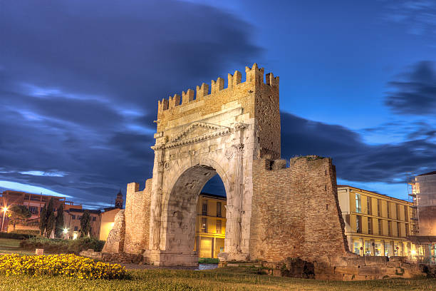 Rimini, the arch of Augustus night view of Augustus arch in Rimini - ancient romanesque gate of the city - historical landmark of Italy, the most ancient roman arch that still stands intact augustus caesar photos stock pictures, royalty-free photos & images