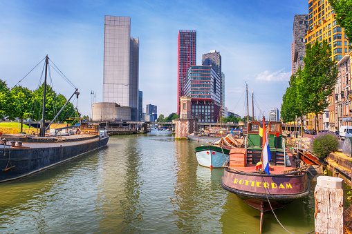 Old boats and modern buildings in Rotterdam city, Netherlands