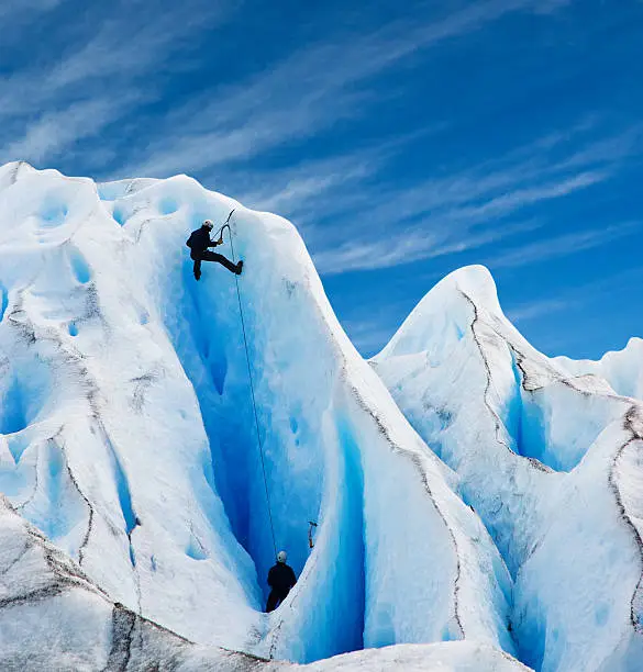 Two men climbing the Perito Moreno glacier in patagonia, Argentina. Copy space.