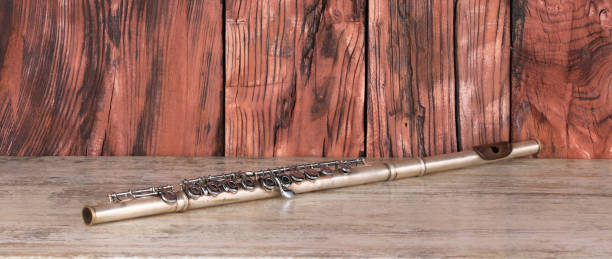 silver flute on wooden table