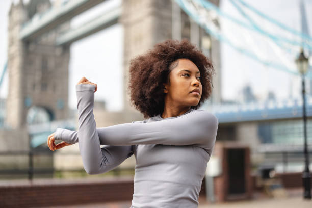 istock Mid-Adult Woman Warming Up Before Running 1539904601