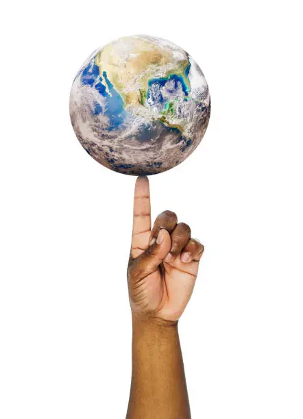 Photo of Environmentalist balances a fragile Planet Earth on the tip of his index finger