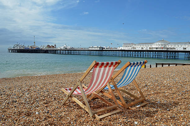 Deck chair on a beach Panorama of Brighton Pier, from a beach east sussex photos stock pictures, royalty-free photos & images