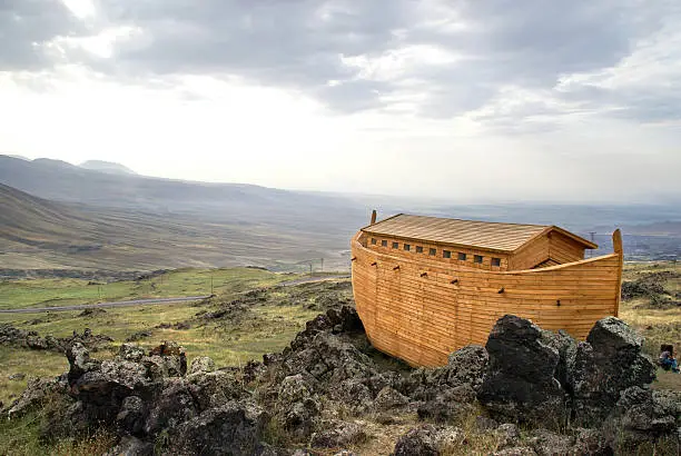 Photo of Noah's Ark docked on rocks overlooking a landscape