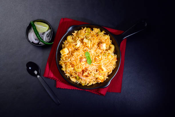 Paneer pulao with onion and lemon, top view Paneer pulao with onion and lemon, top view Pulao stock pictures, royalty-free photos & images