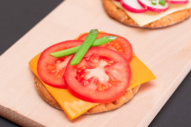 Appetizer from a sandwich with tomatoes, cucumbers and herbs.