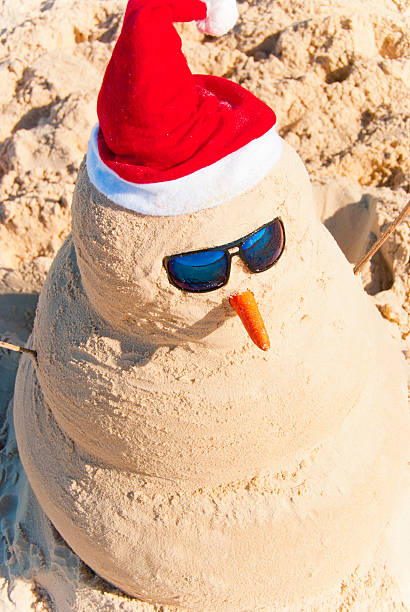 istock Sand Snowman on warm beach at christmas eve 153995548