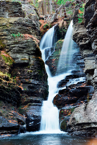 Waterfall with trees and rocks in mountain in Autumn. From Fulmer Falls Pennsylvania Dingmans Falls.