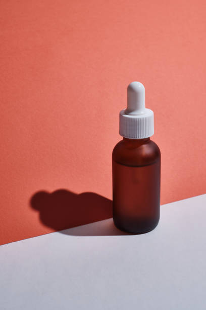 istock Amber glass bottles with a pipette on a colored background. Container packaging design for cosmetics, spa, medicines. Presentation of the concept of natural and organic skin care products 1539979007
