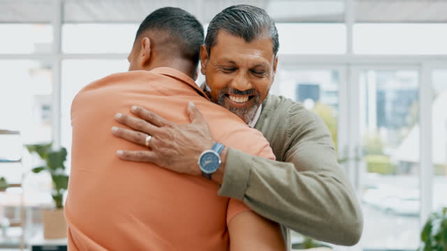 Businessman, hug and welcome partner at office with kindness, happiness and excited at reunion. Father, son and love at family business with hand shake, support and happy in workplace for meeting