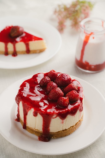 A delicious strawberry cheesecake on a plate.