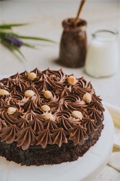istock Decadent chocolate cake garnished with chopped hazelnuts. 1540016719