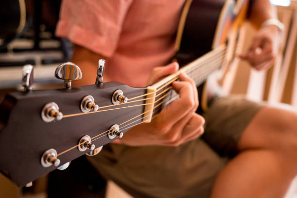 istock Young musician testing classical guitar in a guitar shop 1540019396