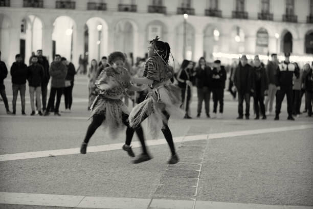 Young, upscale couple run along city street, Trieste