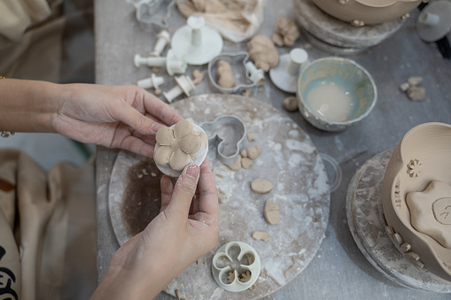 A person is making handmade pottery