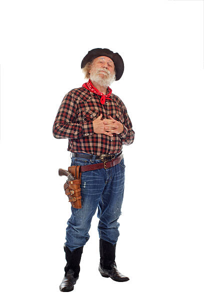 istock Proud Old West cowboy stands with hands clasped 154002479