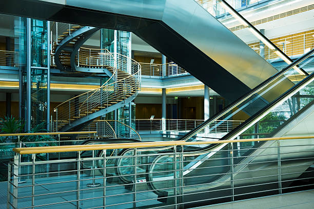 istock Escalators, Elevators and Spiral Stairs in Modern Building Interior 154002775