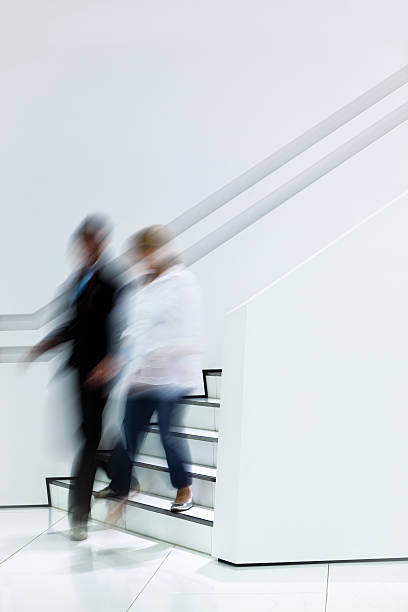istock Young Couple Walking Downstairs 154002800