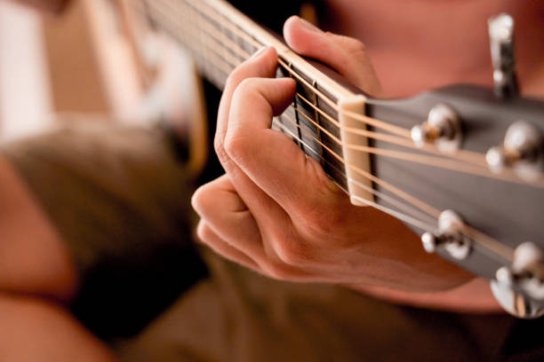 istock Young musician testing classical guitar in a guitar shop 1540029114