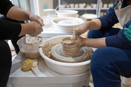 A child is making pottery in a handicraft workshop