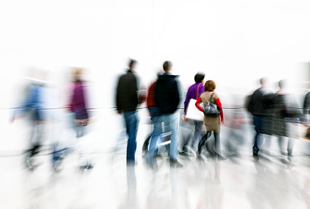 istock Motion Blurred Pedestrians Walking in White Hallway 154003179