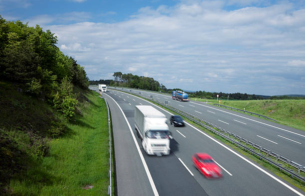 istock Blurred Trucks  and Cars Driving on Highway, Elevated View 154003340