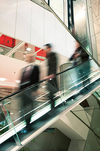 istock Motion Blurr of Businesspeople on Escalator 154003355