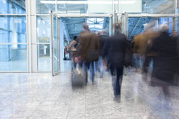 istock Blurred Commuters Walking Through Glass Doors 154003400