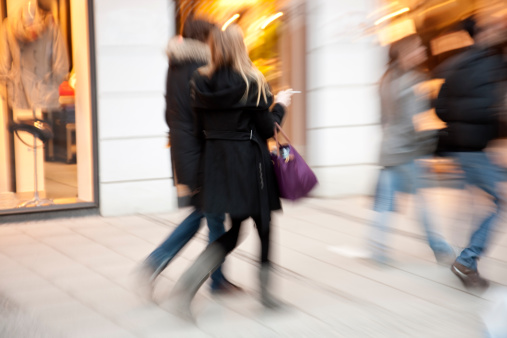 Blurred People Walking Down Shopping Street