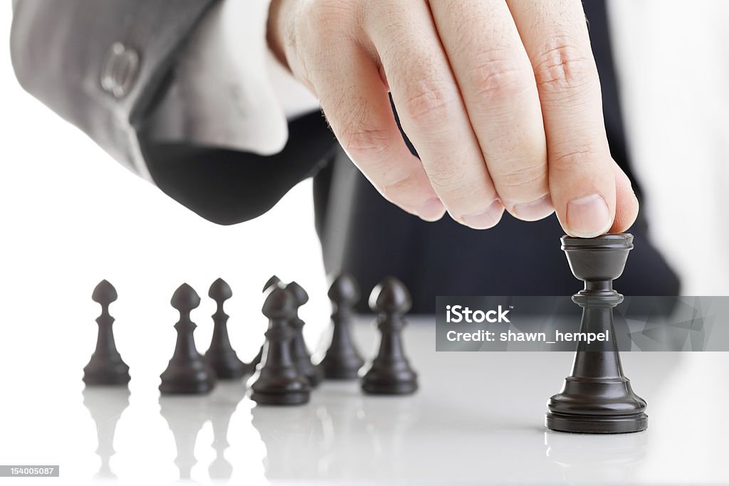 Teamlead Business man moving chess figure with team behind - strategy or leadership concept Activity Stock Photo