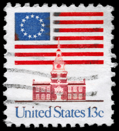A Stamp printed in USA shows the 13-Star Flag, Independence Hall, circa 1975