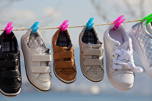 istock Different color and size shoes, hanging on a washing line 154005823
