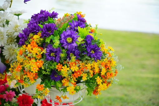 Close-up of the artificial  yellow flower in the basket bike