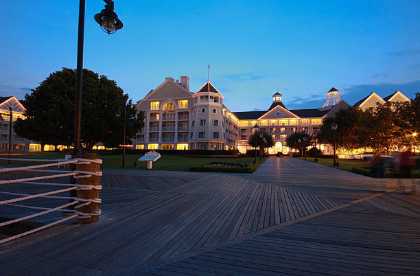 istock Illuminated resort and wooden boardwalk at night 154006606