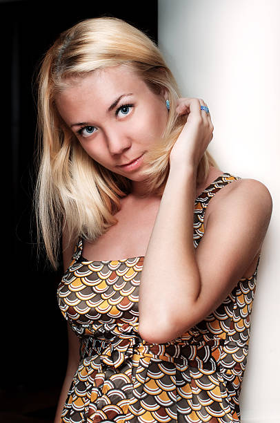 istock beautiful young lady with blue eyes touching her hair 154009242